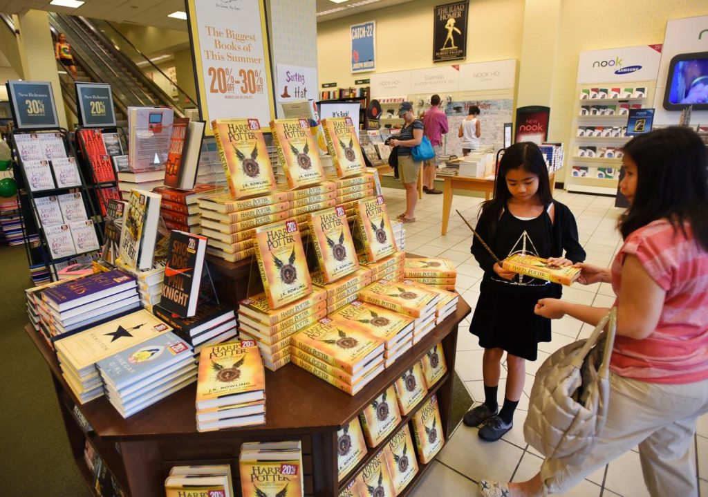 Kids grab up the latest Harry Potter book. Of a play. (Mitsu Yasukawa/The Record of Bergen County via AP)